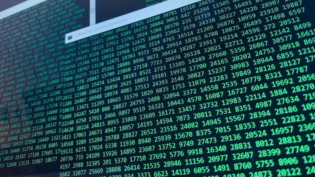 gallery-1 Vibrant green numbers on a computer screen, showcasing binary code and data streams.